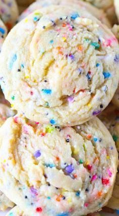 three cookies with sprinkles stacked on top of each other in a pile