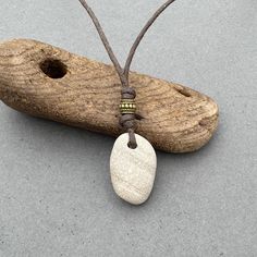 Raw stone necklace, found beige pebble pendant, simple natural rock jewellery, adjustable knotted necklace, stone with a brown cotton cord I found this beautifully shaped beige with faint stripes sea washed pebble on a beach in Cornwall England, and I thought that it would make a great pendant. The beige colour stone has faint markings (veins) which are a darker colour The pebble measures approximately 31mm tall, 29mm wide and 8mm thick, the height of the pendant including the bronze bead and kn Raw Stone Necklace, Knotted Necklace, Colour Stone, Necklace Stone, Cornwall England, Beige Colour