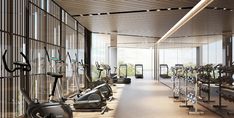 there are many treadmills in the gym with mirrors on the wall behind them