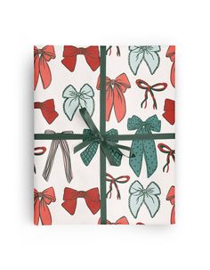 a present wrapped in green and red paper with bows on it's wrapper