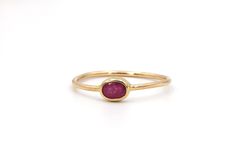 Minimalist, simple ruby solitaire ring using a recycled old oval cut ruby bezel set in a 14k yellow gold ring. Color may vary slightly based on the supply.   DM me for any customization requests.  Round version available https://www.etsy.com/listing/951442768/minimalist-rose-gold-ruby-ring-bezel-set Gemstone: Natural Ruby Cut: oval cut Weight: 1 = 0.33 cts estimated weight Measurements: 4.5 x 3.2 x 2.2 mm Color: pinkish red Clarity: eye visible inclusions Dimensions: 4.2 - 1.1 mm wide x  2.1 mm off the finger Finger Size: size 6 current in stock Metal: available in 14k rose gold, 14k white gold & 14k yellow gold (specify at checkout) Markings: none Weight 0.8 grams Condition Rating: 10 (new ring set with recycled old ruby) Gold Ruby Ring With Bezel Setting, Oval Cabochon, Oval Stackable Ruby Ring In Yellow Gold, Minimalist Oval Stackable Rings With Bezel Setting, Minimalist Gold Ruby Ring With Bezel Setting, Dainty Oval Ruby Ring In Gold, Dainty Gold Oval Ruby Ring, Classic Oval Stackable Ruby Ring, Classic Oval Ruby Ring Stackable, Minimalist Oval Ruby Ring For Anniversary