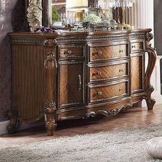 an ornate dresser and mirror in a room