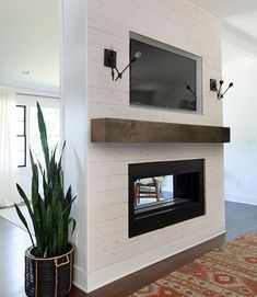 a living room with a television mounted on the wall