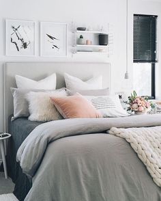 an instagram photo of a bed with pillows and blankets