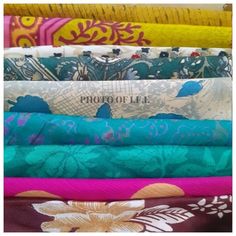 a stack of different colored fabrics with the word photo up written on them in white