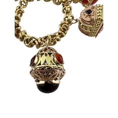 This beautiful mid century modern Etruscan revival bracelet is set in 18K yellow gold.   This heavy bracelet is set with assorted semi precious stones. - light scratching, chips to some stones as shown  2 of the charms open as shown.   8" in length from end to end, approx. 7" wrist size  106.8 g / 68.6 dwt  Stamped 750  Charms up to 35mm in length and 24mm wide  Bracelet is approx. 11mm wide  Very good preowned condition. Just polished by our jeweler.  Will be shipped express mail with insurance Antique Metal Bracelet With Charms, Yellow Gold Metal Bracelet With Vintage Charm, Antique Charm Bracelet Jewelry, Antique Charms Bracelet Jewelry, Heirloom Multi-stone Yellow Gold Jewelry, Heirloom Charms Jewelry For Collectors, Engraved Heirloom Metal Jewelry, Antique Yellow Gold Bracelets With Vintage Charm, Ornate Pendant Jewelry With Charms