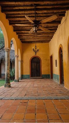 the inside of a building with an archway and ceiling fan on it's side