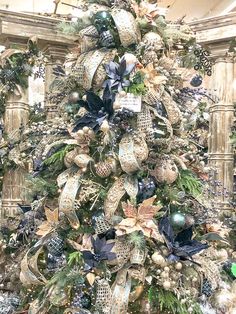 a decorated christmas tree with blue and gold ornaments