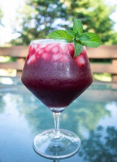 a close up of a drink in a wine glass with the words super healthy and so delicious beet and ginger cocktail