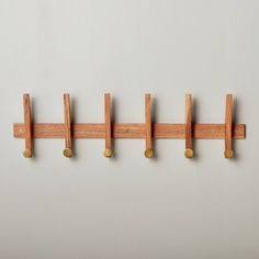 three wooden pegs are hanging on the wall