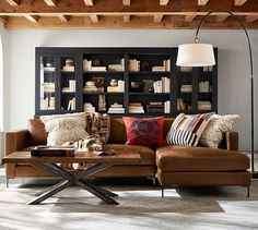 a living room filled with lots of furniture and bookshelves on top of each other