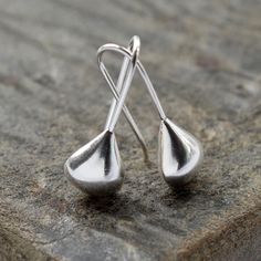 These beautifully simple Sterling Silver April Shower Drop Earrings have a silver liquid metal effect giving them the fresh flowing appearance of a raindrop. Our contemporary design silver teardrop earrings are simply made to wear with an easy, no fuss fixed hook drop setting. The polished finish and silver liquid metal effect make the earrings appear like recently formed drops of april rain slowly moving over a leaf.  All Martha Jackson jewellery is beautifully presented in a gift box complete with a blank gift card for you to write a short message on. made from: Sterling silver with a polished finish. Keep clean with an anti tarnish cloth. dimensions: Overall length 2cm. Teardrop width 0.7cm. Modern Silver Teardrop Earrings, Modern Silver Teardrop Pendant, Modern Teardrop Earrings With Pearl Drop, Minimalist Silver Long Drop Teardrop Earrings, Minimalist Silver Long Drop Earrings, Minimalist Nickel-free Teardrop Earrings, Minimalist Silver Drop Earrings, Silver Teardrop Earrings With Matching Set, Silver Long Drop Teardrop Earrings