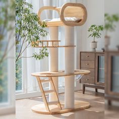 a cat tree in the middle of a living room with a potted plant next to it