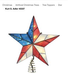 a red, white and blue star hanging from a tree topper