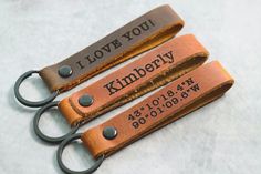 two personalized leather keychains are shown with the names of your loved one