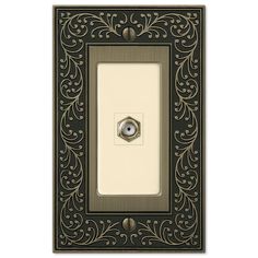 an ornate light switch plate with a decorative design