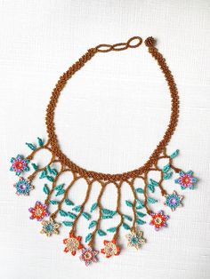 The Jardín (Garden) Necklace will bring any neutral outfit to life with a burst of color! These necklaces are made by Inga Awaska, Inga Women Artisans from Putumayo, Colombia. Details: - Material: Seed Beads - Ball and Loop Closure (look carefully, most have two loops for adjusting the size, but can vary between 1-3 loops). Get a matching bracelet or try these earrings for a bold look! Bohemian Brown Flower Necklace, Multicolor Beaded Necklaces With Nature-inspired Style, Handmade Multicolor Beaded Necklaces, Nature-inspired, Handmade Nature-inspired Beaded Necklaces For Jewelry Making, Handmade Flower Necklace In Nature-inspired Style, Handmade Multicolor Nature-inspired Beaded Necklaces, Handmade Flower Necklace With Nature-inspired Style, Multicolor Bohemian Flower Necklace For Jewelry Making, Bohemian Multicolor Flower Necklace For Jewelry Making