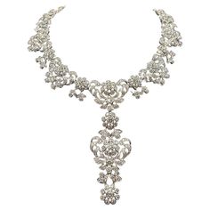 Elevate your jewelry collection with this exquisite Edwardian diamond necklace, meticulously crafted from 18-kt white gold. This custom vintage piece boasts an impressive 35.97-carats of diamonds, radiating timeless elegance and sophistication. The necklace features a detachable centerpiece pendant, allowing versatile styling options to suit any ensemble. Luxury White Gold Diamond Necklace With Intricate Design, Luxury Elegant Filigree Diamond Necklace, Platinum Bridal Necklace With 17 Jewels, Opulent Diamond Necklace For Formal Events, Opulent Diamond Necklace For Formal Occasions, Exquisite Diamond Necklace With 17 Jewels For Evening, Exquisite Evening Diamond Necklace, Luxury Bridal Necklace In Platinum With Single Cut Diamonds, Evening Crystal Diamond Necklace In Fine Jewelry Style