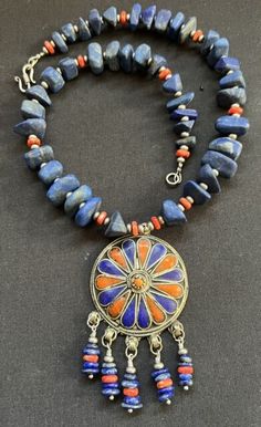 Moroccan Fibulae enameled Tuareg Berber with coral & Lapis Lazuli Boho necklace. | eBay Unique Blue Necklace With Inlay, Artisan Lapis Lazuli Pendant Necklace, Traditional Gemstone Beaded Round Pendant, Traditional Round Pendant Jewelry With Gemstone Beads, Traditional Round Necklaces With Natural Stones, Artisan Blue Inlay Necklaces, Artisan Blue Jewelry For Festivals, Unique Blue Ceremonial Jewelry, Blue Necklace With Round Inlay