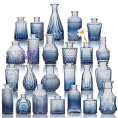 an assortment of blue glass vases and jars