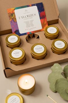 an assortment of candles in a box on a table