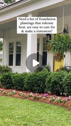 a white house with flowers in the front yard and a sign that says need a list of foundation plants that telerate heat, are easy to care for & make a statement?