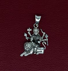 Indian Hindu Idols Blessing Goddess Bhawani/Durga/Santoshi maa with lion vintage antique style stunning divine pendant, best gifting unisex jewelry from India. Metal-925 sterling silver. Item type-Pendant Weight-5.860 grams. Height-4.0 centimeter. Width-2.2 centimeters. Stamped-925. Finish-Oxidized. note: chain is not included in this price. Make excellent gifting and collectible pieces(gifts for birthdays, weddings, anniversaries, mother's day, fathers day, Christmas day,) We take absolute care Symbolic Jewelry For Puja And Navratri, Symbolic Jewelry For Navratri Puja, Hallmarked Jewelry For Puja And Navratri, Hallmarked Round Pendant For Puja, Sterling Silver Necklace For Puja And Diwali, Sterling Silver Necklace For Diwali Puja, Spiritual Oxidized Jewelry For Navratri, Silver Spiritual Necklaces For Navratri, Spiritual Silver Necklaces For Navratri