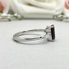 This beautiful ring is made from genuine 925 sterling silver with rhodium plating. Ring details- -The Main stone is an Emerald Cut 8mm by 6mm Lab Created Alexandrite Stone -Side stones are 4mm by 2mm Tapered Baguette simulated diamonds -Ring is casted in solid 925 sterling silver with rhodium plating (rose gold and yellow gold plated also available, please check the drop down menu for more options) -The Total face height of the ring measures 8mms and the band width measures 1.6mms -Each ring is Silver Princess Cut Emerald Ring For Wedding, Wedding Emerald Ring In 14k White Gold, Silver Emerald Ring With Princess Cut And Prong Setting, Silver 14k White Gold Diamond Ring, Emerald Cut, Silver Princess Cut Emerald Ring With Prong Setting, Emerald Cut Sterling Silver Birthstone Promise Ring, Silver Sapphire Ring In Princess Cut, Silver Diamond Promise Ring With Gemstone, Princess Cut Sapphire Ring In Sterling Silver