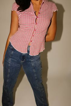 turn any casual outfit idea into a swirlie girlie slay with this collared red gingham button up top. it has a fitted bodice with dainty cap sleeves + vintage-inspired toggle buttons. the perfect summer // fall top to pair with jeans + sneakers, or a mini skirt + loafers. cherry // collared, buttons, cap sleeves, darts, fitted waist paired with our florida denim model is 5'8" + wearing a small measurements are approximate + taken while laying flat small : bust 32” length 22” medium : bust 34” len Summer Gingham Button-up Tops, Summer Gingham Top With Button Closure, Summer Gingham Top With Buttons, Gingham Summer Tops With Buttons, Fitted Plaid Top For Picnic, Trendy Red Tops For Picnic, Fitted Retro Tops For Picnic, Retro Fitted Tops For Picnic, Retro Fitted Gingham Tops