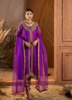 Introducing our stunning Purple Organza Outfit! This elegant dress is adorned with intricate details, featuring beautiful embroidery and embellishments. The rich purple color adds a regal touch, and it comes with a chooridar pajama for a complete look. Perfect for making a statement at special occasions! Purple Silk Sharara For Navratri, Purple Chanderi Sharara For Navratri, Elegant Purple Kurta With Sheer Dupatta, Bollywood Purple Raw Silk Sharara, Purple Bollywood Raw Silk Sharara, Bollywood Style Purple Raw Silk Sharara, Designer Art Silk Purple Kurta, Traditional Purple Sharara With Dupatta, Purple Chanderi Sharara With Traditional Drape