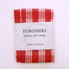 a red and white checkered fabric with the words furoshiki on it