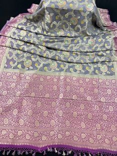 Pure Moonga Banarasi Silk Handmade Saree with Floral Jaal with Brush Paint. Item : SareeBase Fabric : Pure Moonga Banarasi SilkColor : Grey and Pink Blouse piece : Comes with un-stitched Blouse piece.Fall & Edging(Yes/No) : Yes Disclaimer :-- Color variation is possible due to various reasons like phone or desktop setting, resolution etc. Please don't hold us responsible. Our aim is to put the exact color of the Saree.- If the Saree is Pure Silk, we will put it very clearly in our listing that i Purple Zari Work Dupatta For Transitional Season, Transitional Purple Dupatta With Zari Work, Purple Bollywood Dupatta For Transitional Season, Festive Purple Traditional Wear With Meenakari, Festive Purple Meenakari Traditional Wear, Purple Dupatta For Puja And Transitional Season, Purple Transitional Dupatta For Puja, Purple Meenakari Traditional Wear For Eid, Purple Jamawar Traditional Wear For Diwali