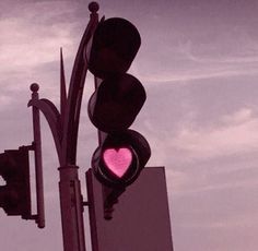 a traffic light with a pink heart on it