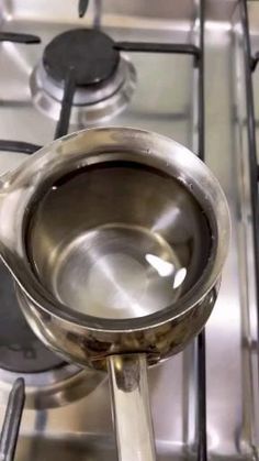 a stainless steel stove top with a frying pan on it's burner