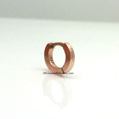 Handmade from solid 14K rose gold. This tiny hoop earring measures approximately 5mm inner diameter. Great for helix, tragus, anti tragus, daith, eyebrow, or rook piercings. Sold as a single hoop cartilage earring. Product attributes Metal: high quality 14K solid rose gold Inner diameter: 5mm Width: 1.4mm Ear post: 20G. Can be customized to other gauges. 14K white gold polished https://www.etsy.com/listing/127764306 14K white gold matte https://www.etsy.com/listing/179694245 Thank you for your i Rose Gold Internally Threaded Hoop Septum Ring, Rose Gold Huggie Jewelry With Spring Ring Clasp, Rose Gold Single Cartilage Earring For Everyday, Everyday Hypoallergenic Rose Gold Cartilage Earrings, Minimalist Rose Gold Huggie Earrings, Minimalist Rose Gold Small Hoop Piercings, Nickel-free Rose Gold Cartilage Earrings, Nickel Free Rose Gold Cartilage Earrings, Rose Gold Tarnish-resistant Cartilage Earrings For Everyday