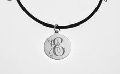 This elegant necklace is sure to bring you many compliments !  I will carefully engrave a single, beautifully ornate script initial on this high polish 7/8" diameter sterling silver disc.  Take a look at the last picture - I have engraved a sample of each letter, so you can see what yours will look like! This lovely necklace is suitable for every day wear or formal events.The finished piece will be suspended on your choice of:*16" rubber cord with stainless steel lobster clasp or*18" rubber cord Elegant Stainless Steel Medallion Necklace, Engraved Stainless Steel Jewelry With Initial Pendant, Engraved Stainless Steel Medallion Jewelry, Classic Engraved Adjustable Necklace, Classic Adjustable Engraved Necklaces, Classic Adjustable Engraved Necklace, Engraved Stainless Steel Necklace For Anniversary, Round Stainless Steel Jewelry With Engraving Option, Classic Engraved Pendant Necklace