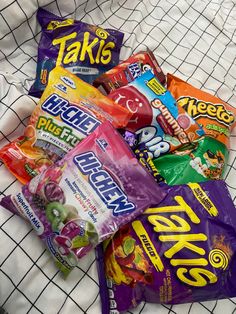 many different types of candy on a bed