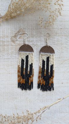 These earrings are perfect for a cactus lover! Embracing black and browns add a warm and classy tone to these earrings. These earrings are beaded by hand and the topper is made out of genuine leather. You can choose between gold, silver and bronze hardware that is hypoallergenic and sensitive safe.  Approx. 3.5 inches long Note: If you would like different colors please do not hesitate to reach out. We love custom orders and have an array of colors. Native American Fringe Earrings, Handmade Black Earthy Jewelry, Unique Brown Beaded Earrings As Gift, Unique Brown Beaded Earrings For Gift, Handmade Brown Bohemian Beaded Earrings, Earthy Brown Earrings For Festivals, Bohemian Brown Beaded Earrings For Gift, Artisan Brown Beaded Earrings With Dangling Beads, Brown Round Bead Earrings For Festivals