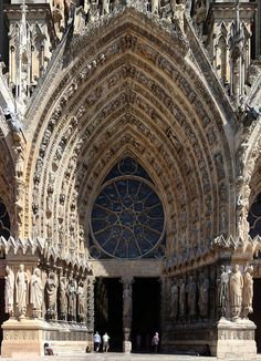 the entrance to an old cathedral with statues on it