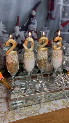 candles are lit in the shape of numbers for new year's eve on a table