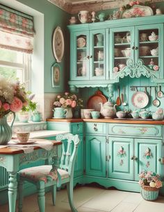 an old fashioned kitchen with blue cabinets and pink flowers