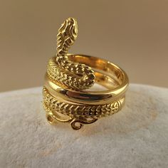 Snake ring made of 18 carat solid yellow gold Snake was the symbol of health in ancient Greece It's made with detailed handmade workmanship Made in Greece in our workshop in Athens A beautiful piece of jewelry that can be an unique gift for any special occasion For more information don't hesitate to contact us SHIPPING INFORMATION FREE SHIPPING VIA DHL EXPRESS Please fill in an active phone number It's required by the courier company DELIVERY TIME INFORMATION 1 - 3 Days EUROPE 3 - 5 Days to U.S. 22k Gold Antique Rings For Ceremonial Occasions, Antique 22k Gold Rings For Ceremonial Occasions, Antique 22k Gold Ceremonial Rings, Elegant Yellow Gold Ceremonial Rings, Elegant Ceremonial Yellow Gold Rings, Yellow Gold Symbolic Carved Jewelry, Carved Symbolic Yellow Gold Jewelry, Luxury Yellow Gold Snake Ring With Polished Finish, Luxury Polished Yellow Gold Snake Ring