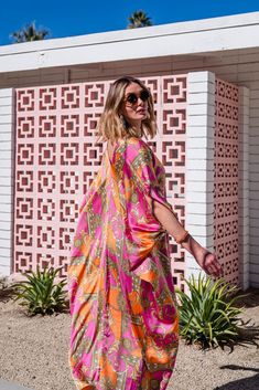 This colorful caftan is the answer to glam layering.. This exquisite garment is more than just a piece of clothing; it's a celebration of fabric in all its glory. Crafted with generous amounts of a ultralight satin rayon and lots of love, this piece offers an airy fit designed to drape beautifully on all body types. Whether worn poolside for a day at the cabana or layered and adorned with your favorite accessories for a glamorous evening affair, it's a versatile wardrobe staple that effortlessly Pink Maxi-length Kaftan For Festivals, Festive Pink Floor-length Kaftan, Luxury Pink Printed Kaftan, Pink Summer Maxi-length Kaftan, Pink Embroidered Maxi-length Kaftan, Loungewear Dress, Plus Sized, Versatile Wardrobe, Caftan Dress