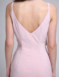 the back of a woman's pink dress