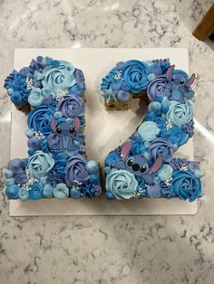 the letter e is made out of cupcakes and frosted with blue icing