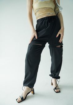 It doesn't get more functional than the Double Take Utility Pant. One minute they're the chicest, most comfortable activewear pant of your dreams, and the next they're your favorite high waisted active shorts. The pants feature two cargo pockets, hidden zippers for a seamless transition into shorts, and adjustable ankles to make it as easy as possible to slip the bottom half off over your sneakers. Running from afternoon workout to a fun happy hour with friends? Ditch the sneakers, cinch the adj Sporty High Waist Pants With Built-in Shorts, Outdoor Relaxed Fit Cargo Pants With Built-in Shorts, Outdoor Compressive 2-in-1 Bottoms, Casual Compressive Bottoms With Hip Pockets, Sporty Stretch Cargo Pants For Summer, Compressive Athleisure Bottoms For Streetwear, High Waist Functional Bottoms With Elastic Waistband, Functional High Waist Bottoms With Elastic Waistband, Sporty Cargo Pants With Drawstring For Summer