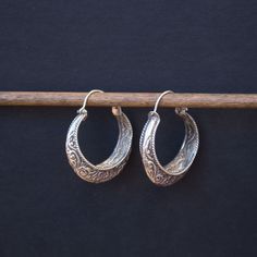 A fine example of traditional Nevari people hand formed silver hoops Approximately 1.5 inches in diameter Traditional Round Engraved Earrings, Traditional Engraved Round Earrings, Small Engraved Hoop Earrings, Traditional Silver Hoop Earrings As Gift, Traditional Silver Hoop Earrings For Gift, Traditional Engraved Hoop Earrings, Traditional Round Jewelry With Sterling Silver Clasp, Traditional Sterling Silver Engraved Earrings, Traditional Engraved Sterling Silver Earrings