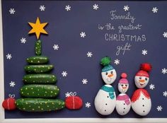 two snowmen and a christmas tree on a blue background