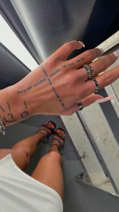 a woman's hand with tattoos on her left arm and the word love written across it