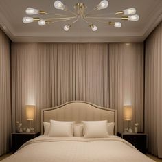 a large bed sitting under a chandelier next to two nightstands and lamps